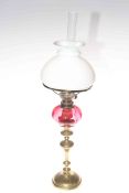 Brass column oil lamp with ruby reservoir and opaque glass shade