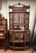 Victorian rosewood parlour cabinet having two glazed panelled doors flanked by bowed shelves above