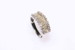 18 carat white gold half eternity ring having a band of baguette cut diamonds flanked either side