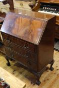 Mahogany three drawer bureau on ball and claw legs