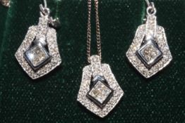 Art Deco style pendant of four princess cut diamonds set in 18 carat white gold,