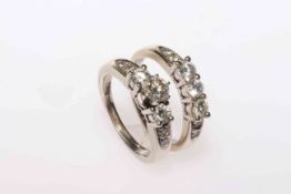 A Pair of diamond engagement and wedding rings set in 14 carat white gold;