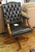 Green deep buttoned leather open arm swivel desk chair