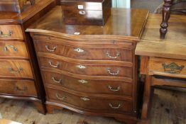 Mahogany serpentine front chest having leather inset slide above four long drawers on bracket feet,