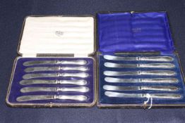 Two sets of cased silver handled tea knives