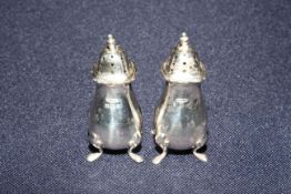 Pair silver pepperettes,