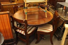 Circular mahogany pedestal dining table and four sabre leg dining chairs
