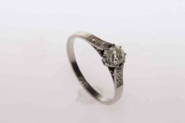 Oval cushion cut diamond ring set in platinum with three small diamonds to each shoulder