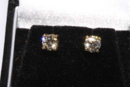 Pair of round brilliant cut diamond stud earrings in 18 carat yellow gold