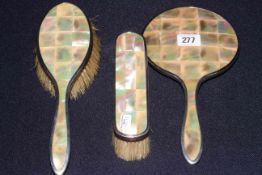 Silver and mother-of-pearl three piece brush and mirror set