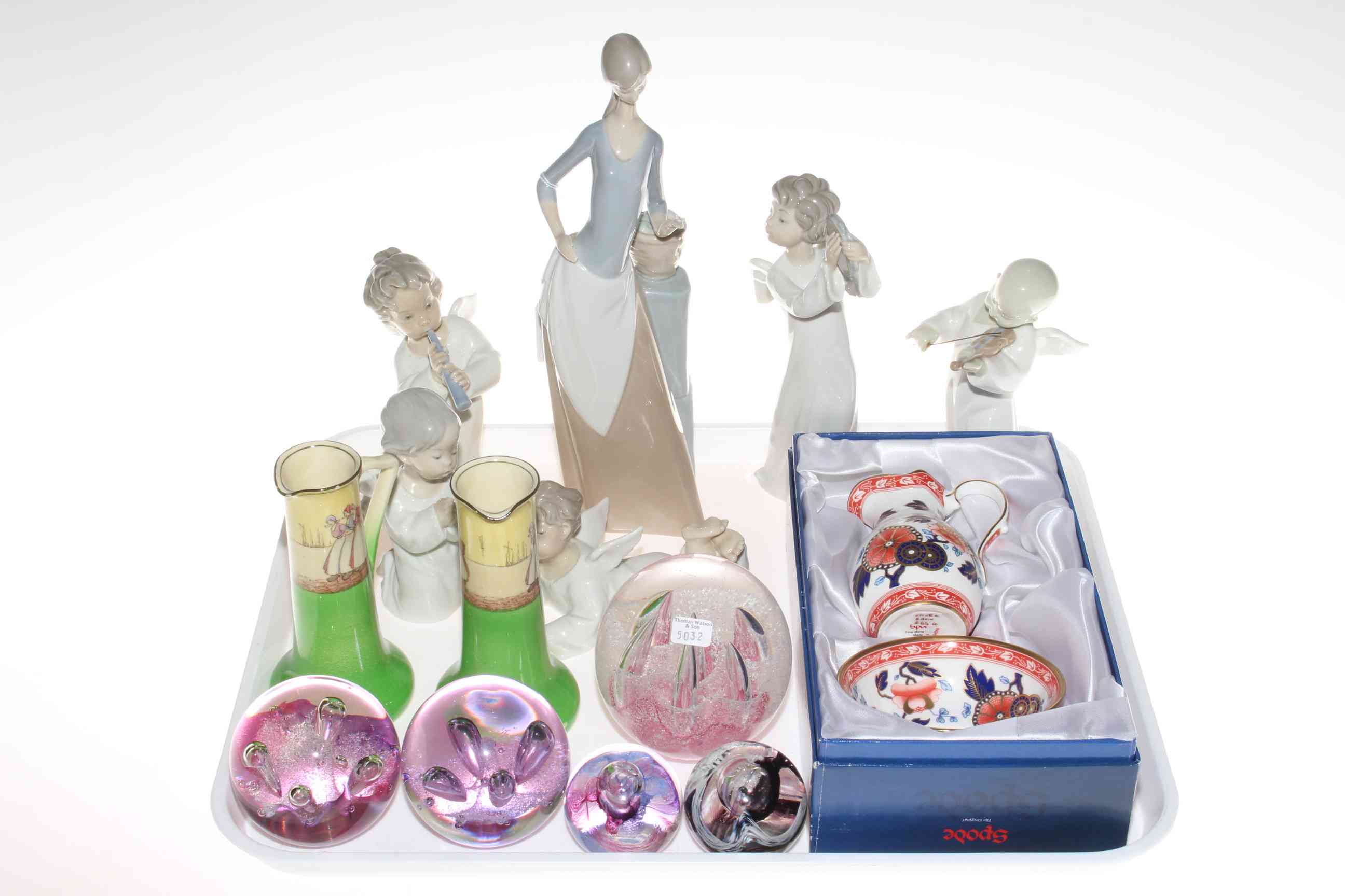 Four Lladro figures, two Nao, glass paperweights,