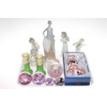 Four Lladro figures, two Nao, glass paperweights,