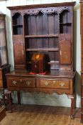 19th Century oak shelf and cupboard back two drawer dresser on cabriole legs,