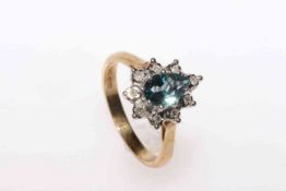 Pear shaped blue topaz and round brilliant diamond cluster ring in 9 carat yellow gold