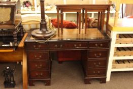 Mahogany eight drawer pedestal desk and mahogany nest of three tables