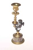 Bronze cherub and ormolu candlestick on marble plinth