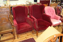 Two early 20th Century wing armchairs in wine crushed velvet