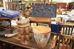 Carved wood stool with heads,