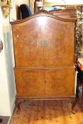 Burr walnut arched top four door cocktail cabinet on cabriole legs,