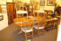 Yew twin pedestal extending dining table and six Hepplewhite style dining chairs including pair