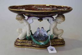 Minton majolica centrepiece, modelled with two cherubs holding swags, circa 1870-80, 16.