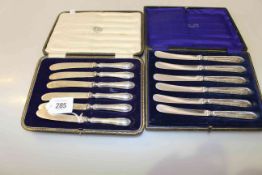 Two boxed sets of six silver-handled tea knives