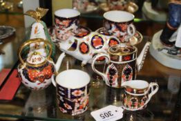 Royal Crown Derby: Pair of cups and saucers, miniature coffee pot and cream jug, coffee can,