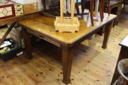 Oak extending table raised on four square tapering legs