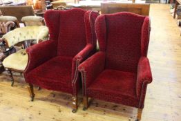 Two oak framed early 20th Century wing armchairs upholstered in red velvet