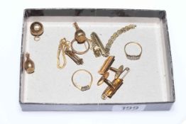 Three gold rings, two gold charms, pair of cufflinks,