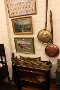 Two open bookshelves, copper and brass warming pans, two brass fenders, irons, two jam pans,