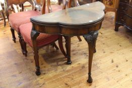 Mahogany demi lune card table raised on carved cabriole legs