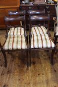 Four Regency style mahogany sabre leg dining chairs