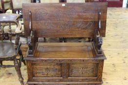 Carved oak monks bench with lion arm supports