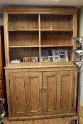 Large pine cupboard having double cupboard base and open shelved top