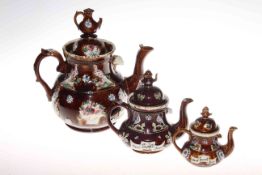 Three graduating Burge Ware teapots
