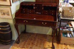 Reproduction mahogany bureau/writing desk having a series of drawers and pigeon holes and raised on