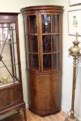 Inlaid mahogany bow front standing corner cabinet having two glazed panel doors above a central