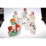 Six Victorian Staffordshire figures and cow spill vases