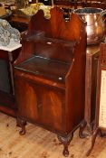 Gallery backed two door mahogany cabinet on cabriole legs,