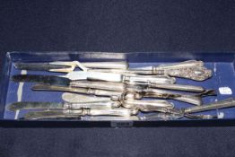 Silver handled knives, toasting fork,