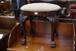 Oval mahogany stool raised on cabriole legs to paw feet