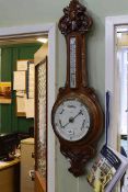 Carved oak barometer-thermometer, the dial signed T.L.