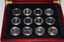 Twelve sterling silver coins in display box, with certificates,