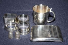 Silver christening tankard, silver cigarette case, four silver napkin rings,