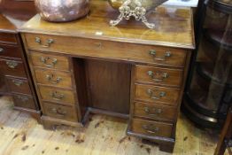 Georgian mahogany kneehole desk having long drawer above two banks of four drawers and central