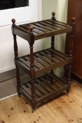 Stained three tier luggage rack with turned supports, 107cm by 59.