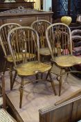 Set of four Windsor elm pierced splat back dining chairs with crinoline stretchers