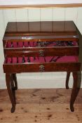 Walnut three drawer table canteen on cabriole legs containing a part canteen of community cutlery