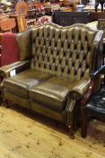 Deep buttoned leather two seater wing back settee